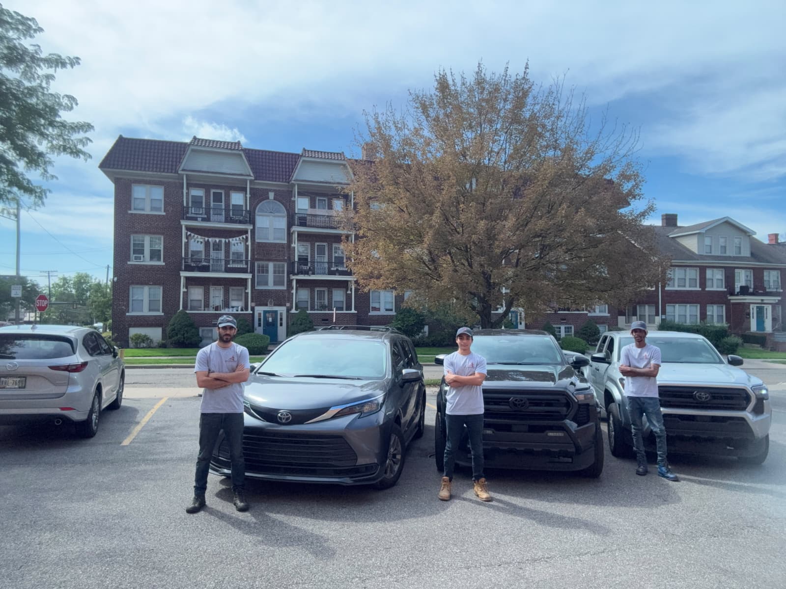 The Chimney Expert Solutions crew in branded shirts beside their vehicles