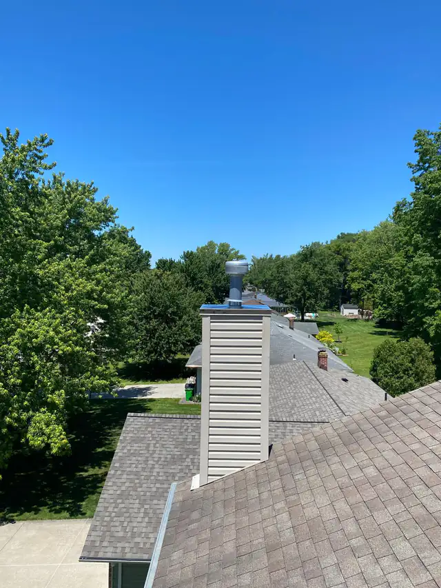 The replacement metal cover fitted on the same sided chimney chase, viewed from the roof
